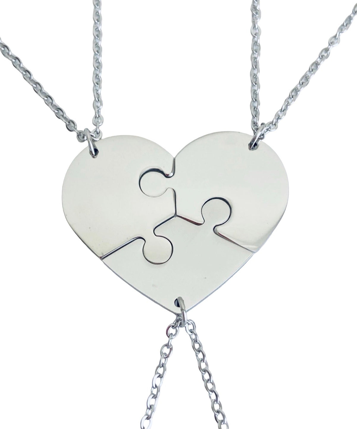 A silver heart-shaped pendant necklace made of three interlocking puzzle pieces, suspended from a delicate silver chain against a plain white background.