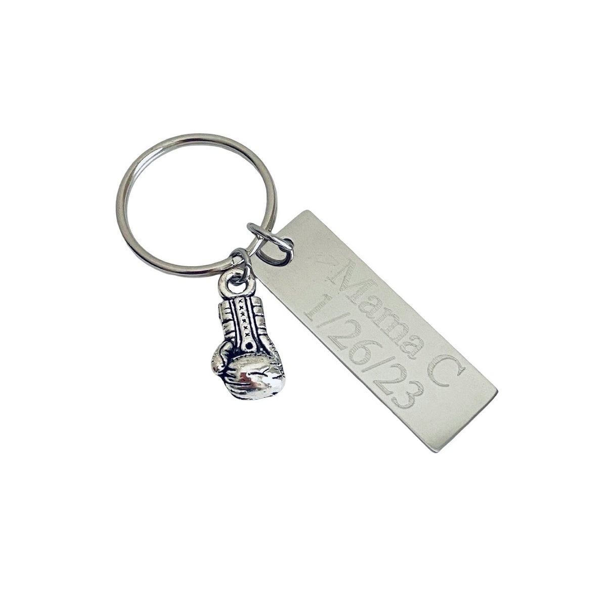 A silver metal keychain featuring a rectangular engraved tag that reads 'Mama C 1/26/23' and a small boxing glove charm, shown on a plain white background.