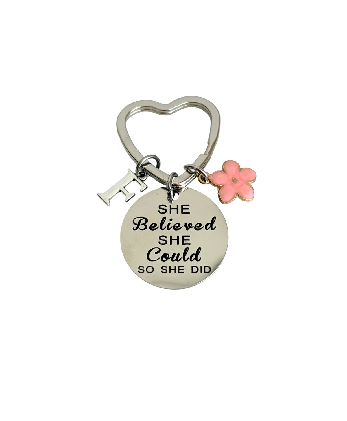 Keychain with 'She believed she could so she did' quote on a white background