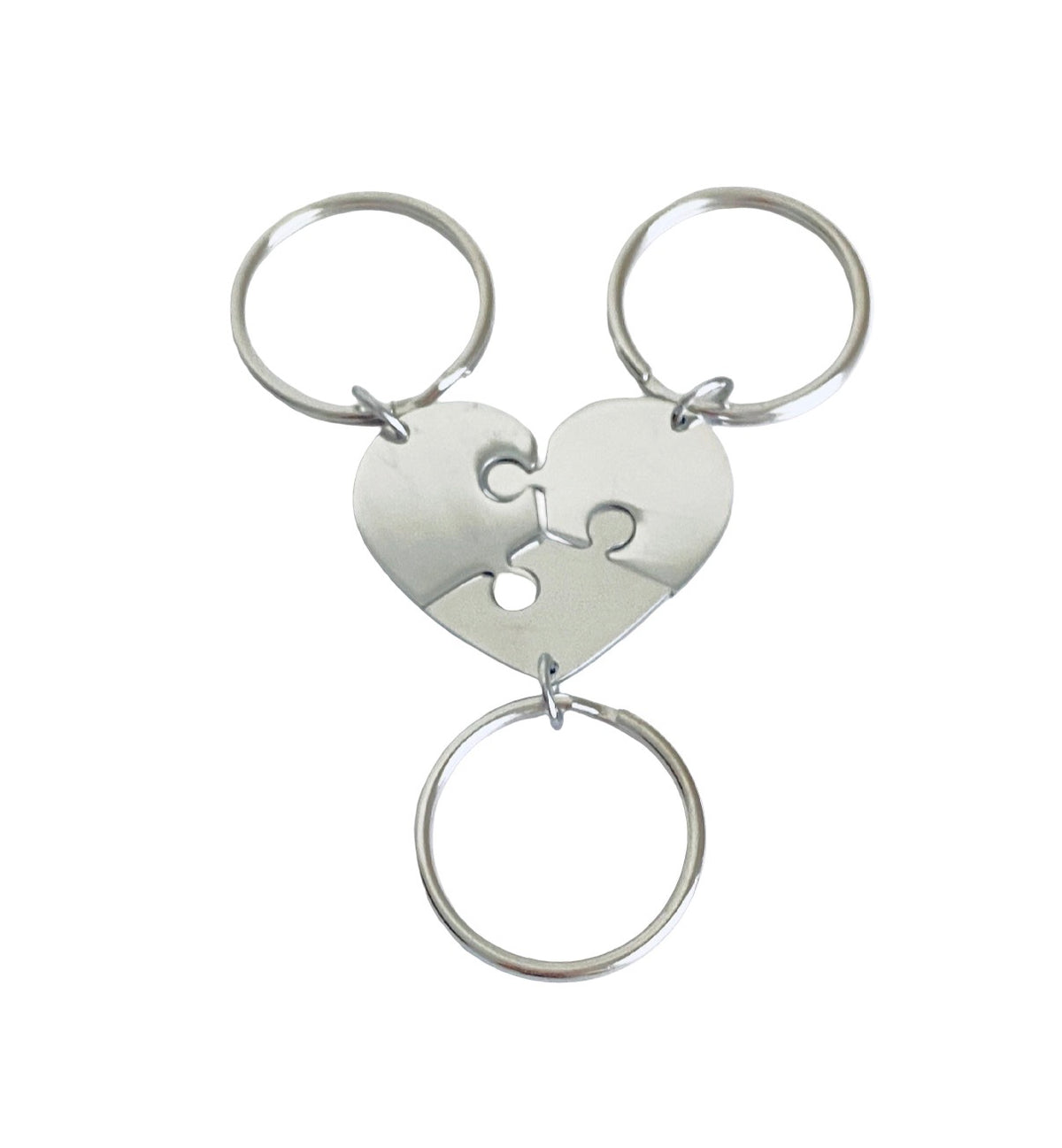 A silver-toned metal keychain featuring a puzzle heart charm with three interlocking circular rings, shown on a plain white background.