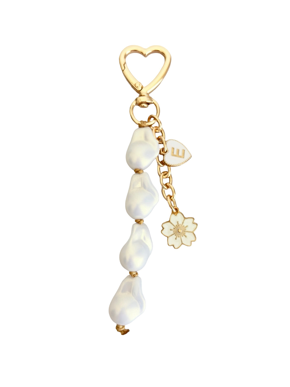 A gold-toned dangle charm featuring a heart-shaped clasp, four teardrop-shaped white beads, a small chain with a monogram 'W' charm, and a flower charm, set against a plain white background.