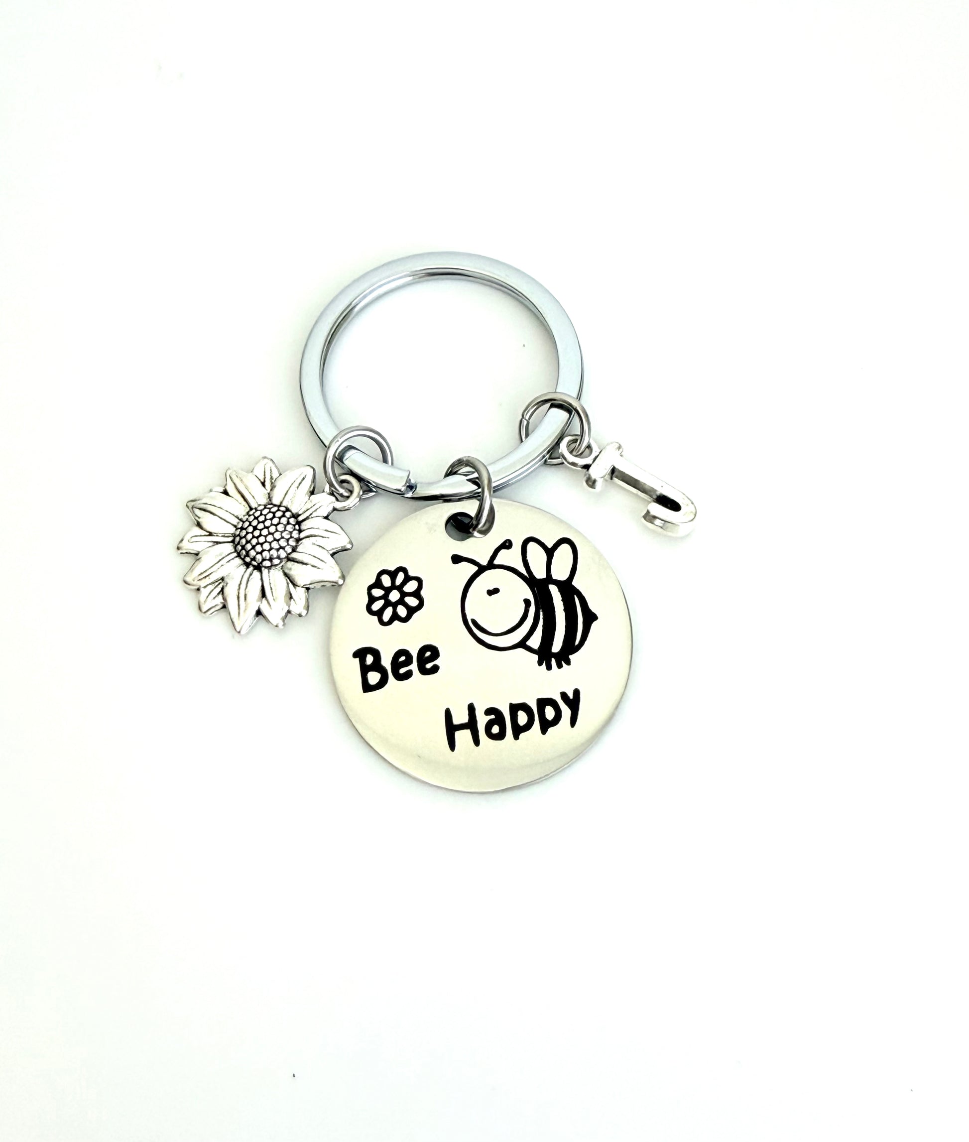 Keychain with 'Bee Happy' charm on a white background