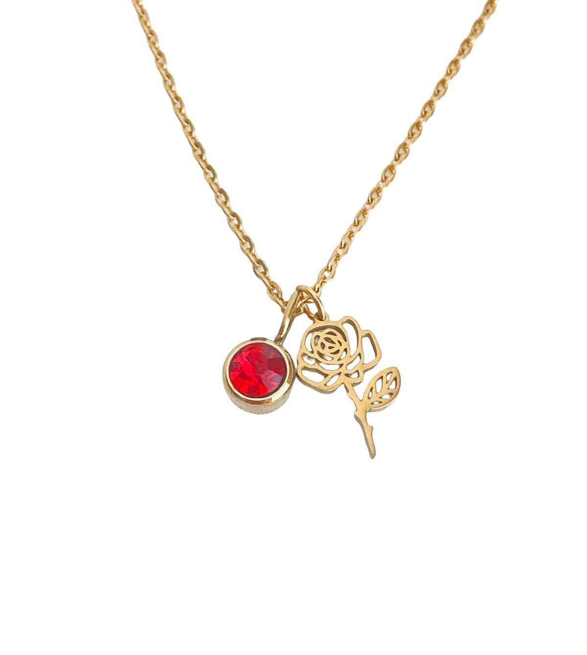 A gold chain necklace featuring a small pendant with a round red gemstone and a gold rose charm, displayed against a solid white background.
