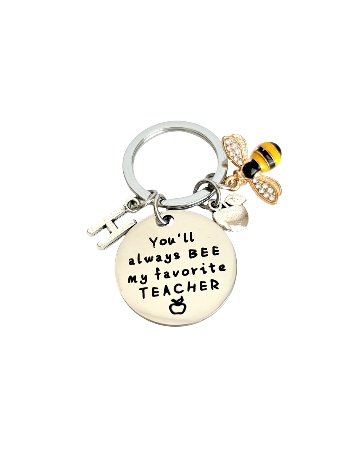 Keychain with bee charm and engraved message on a white background