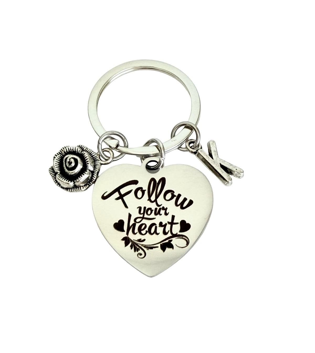Keychain with heart-shaped charm reading 'Follow your heart' on a white background