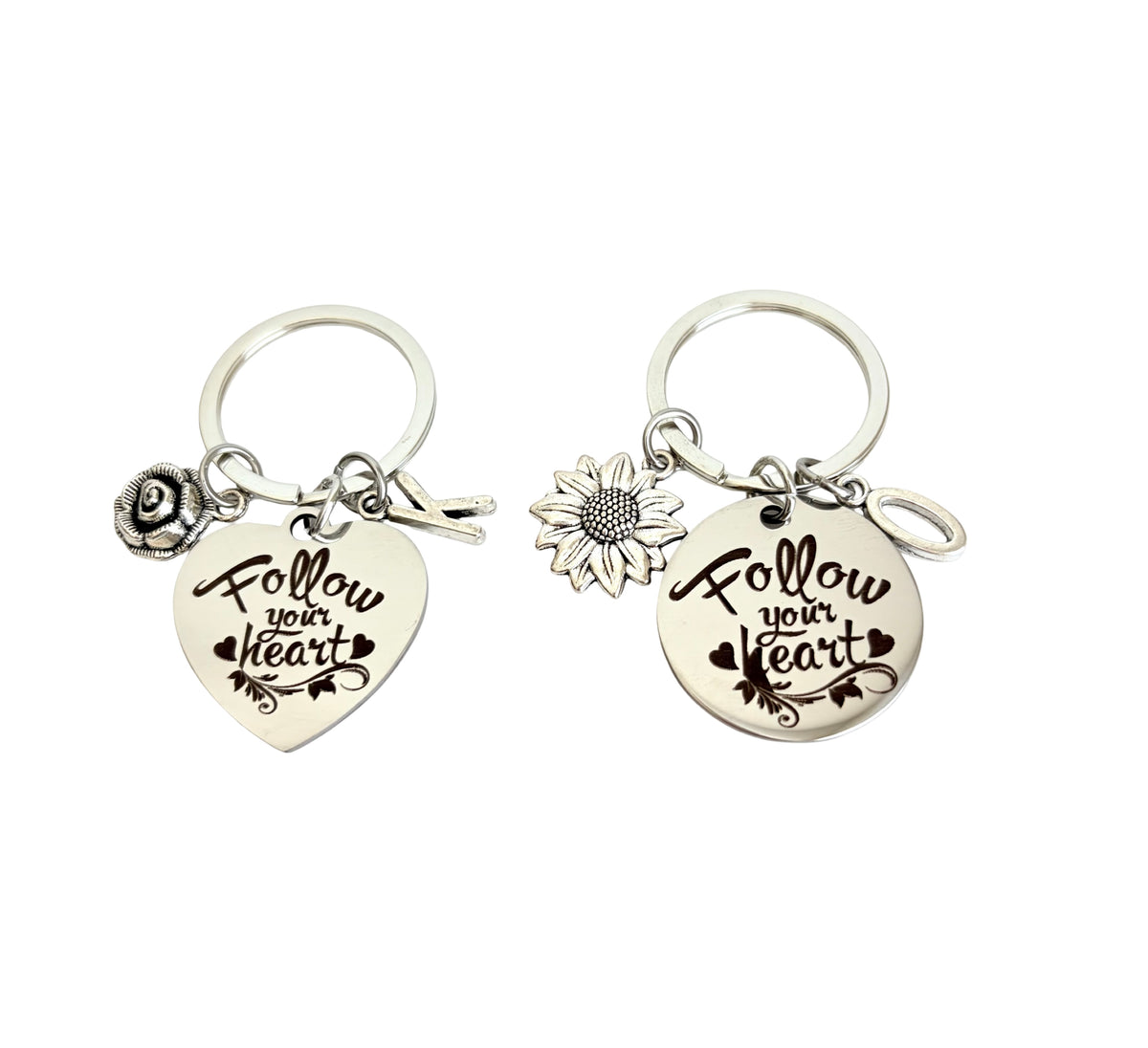 Two keychains with 'Follow your heart' text and floral designs on a white background