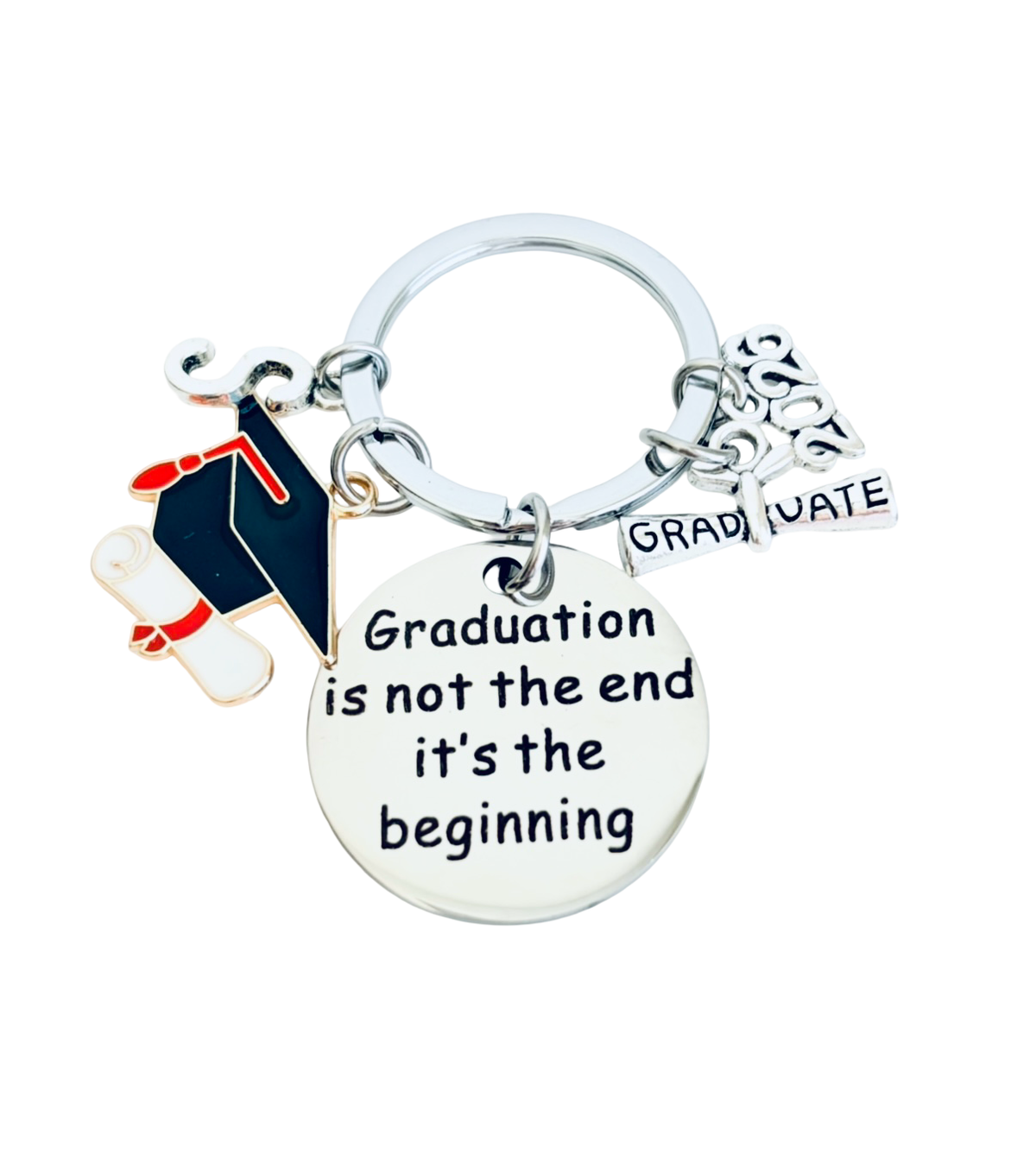 Graduation-themed keychain with charms and a quote on a white background