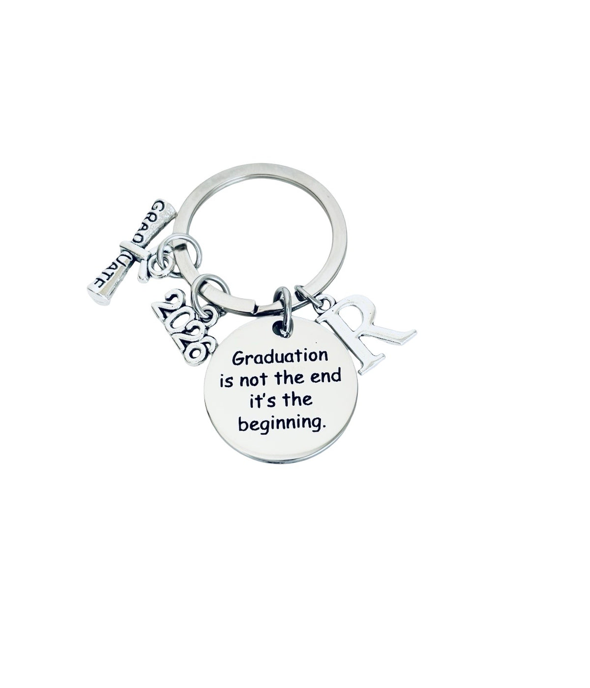 Silver keychain with 'Graduation is not the end, it's the beginning' quote on a white background