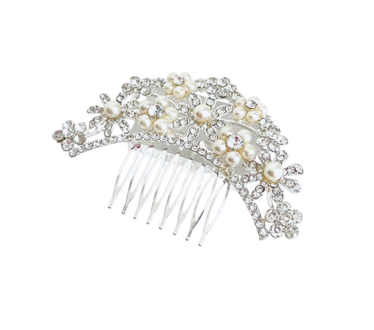 A bridal hair comb featuring a silver-toned metal base adorned with faux pearls, clear rhinestones, and floral motifs, set against a plain white background.