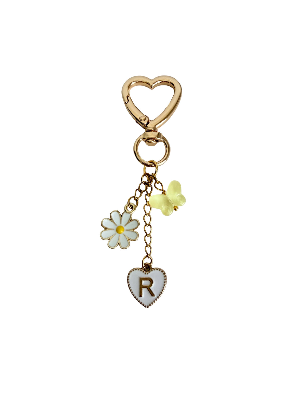 Keychain with heart, flower, and letter 'R' charm on a white background