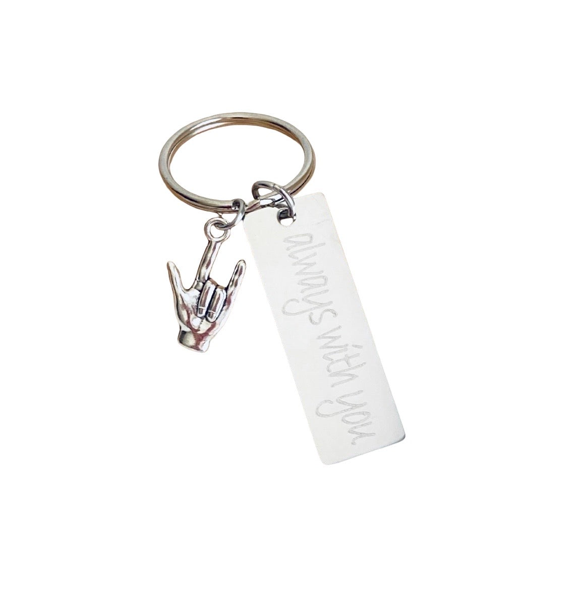 A silver-toned metal keychain featuring a split ring, a rectangular bar engraved with 'always with you.', and a small hand gesture charm, shown on a plain white background.