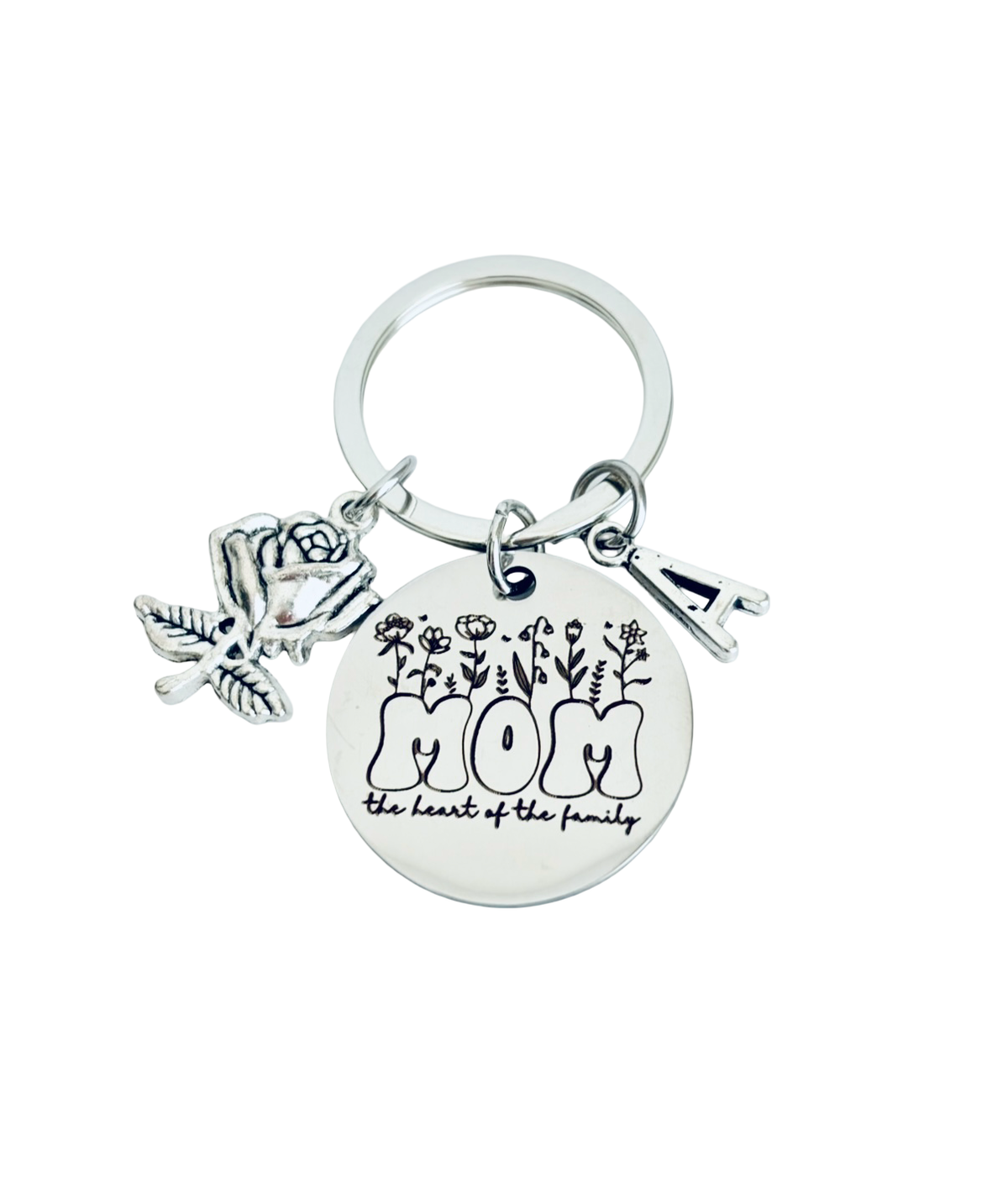 Silver keychain with 'mom' and floral design on a white background