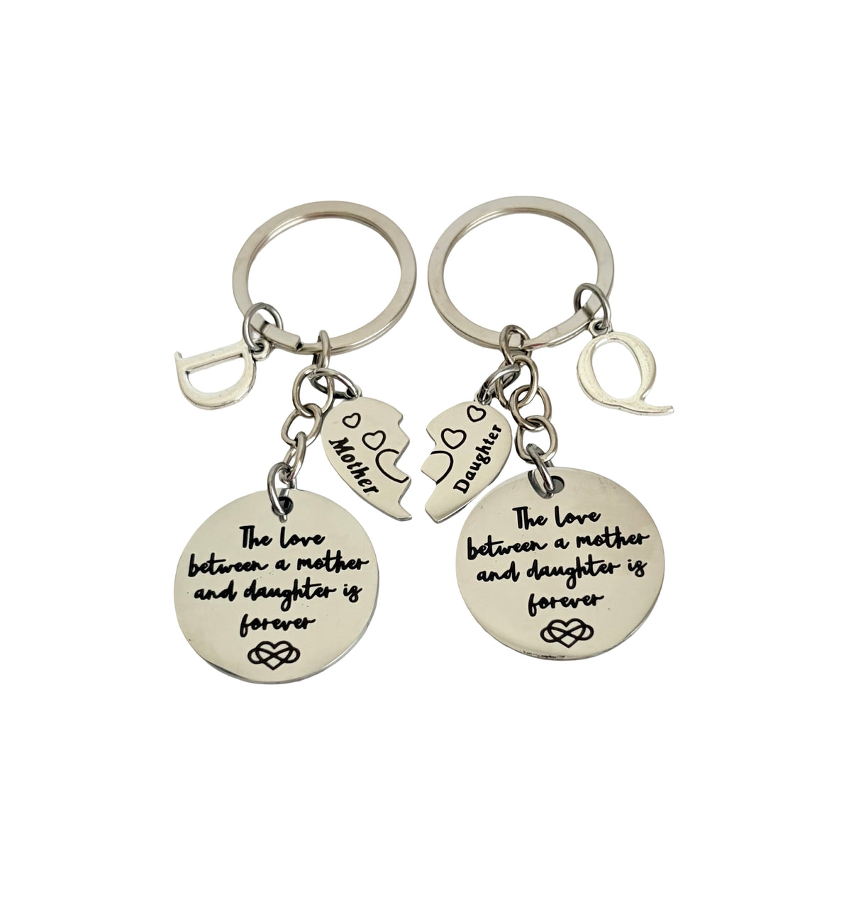 Two silver keychains with engraved text on a white background