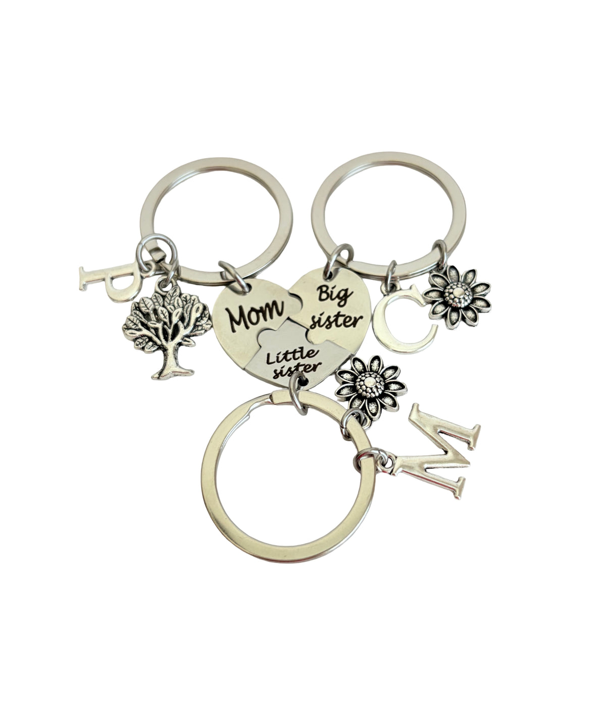 Keychain with various charms including a heart, tree, and flowers on a white background