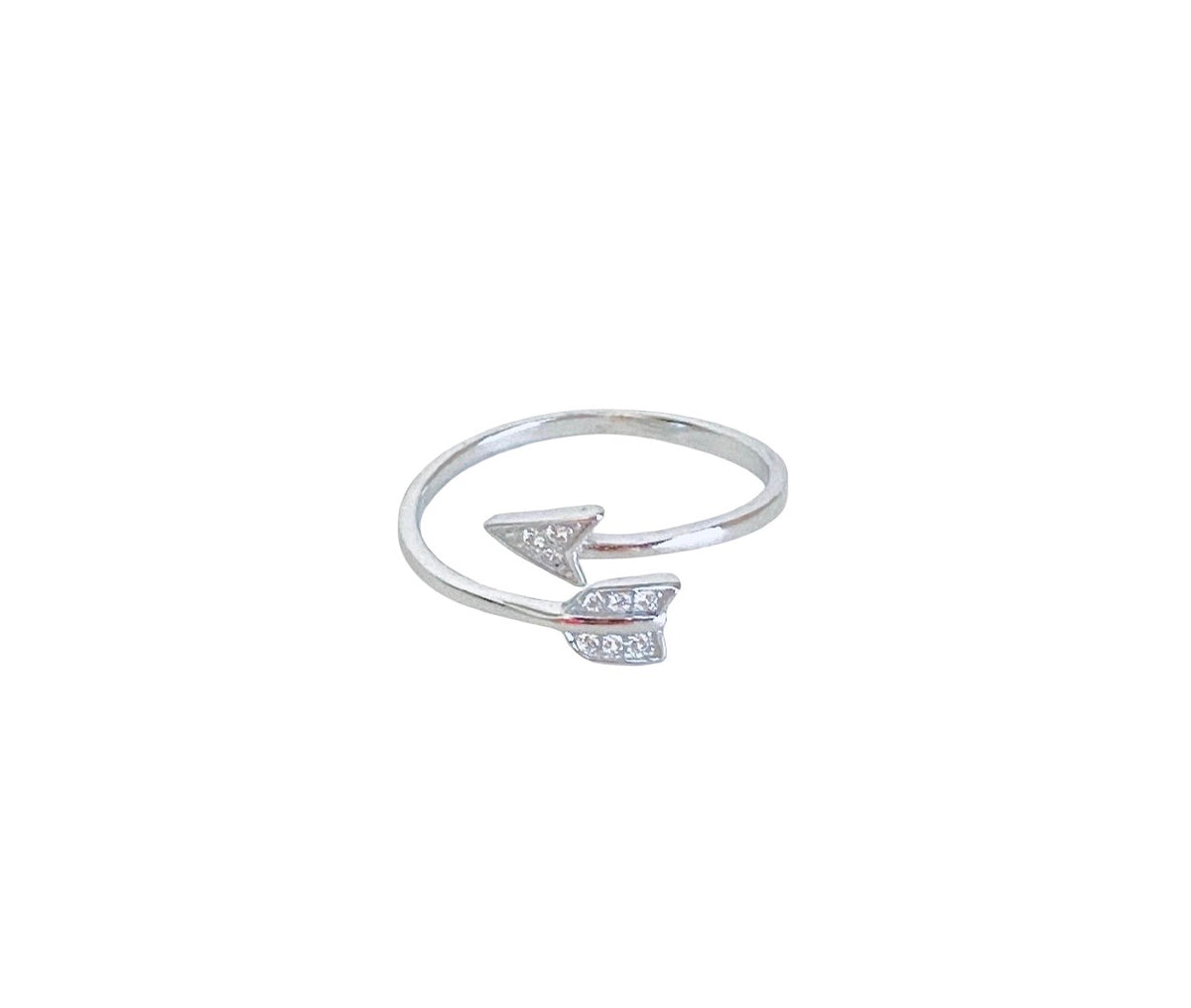 A silver-toned open ring band featuring a small arrowhead charm paved with clear stones, shown on a plain white background.