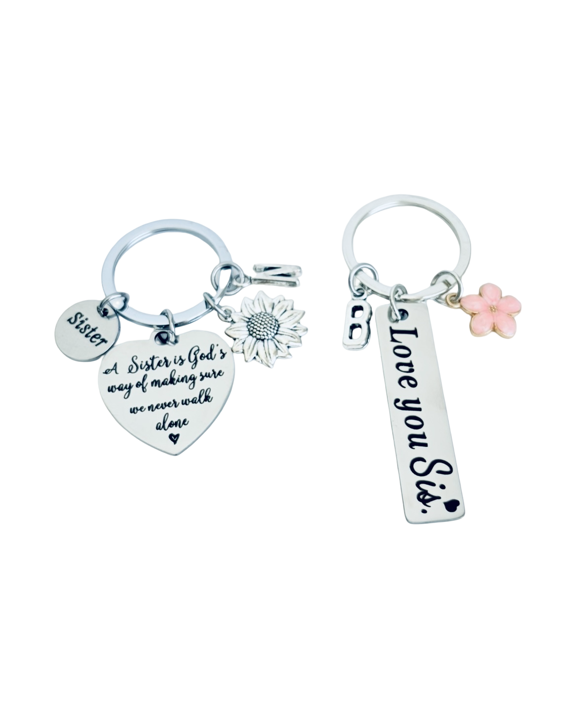 Two silver keychains with charms on a white background