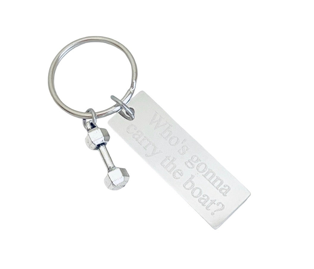A silver metal keychain featuring a rectangular engraved tag that reads 'Who's gonna carry the boat?' and a small dumbbell charm, shown on a plain white background.