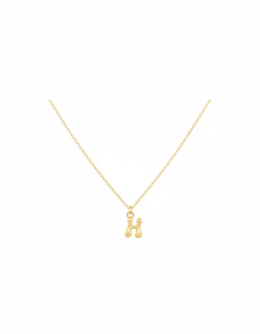 A delicate gold chain necklace featuring a small, polished gold letter 'H' pendant, presented on a clean white background.