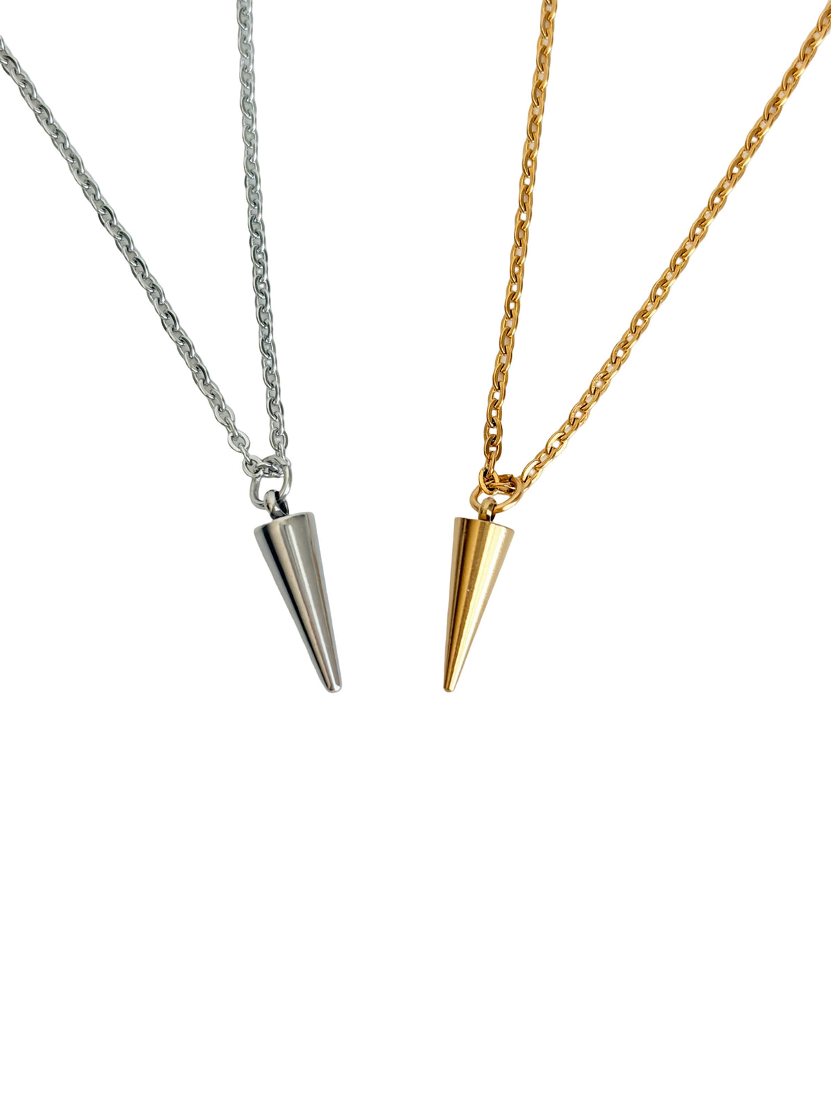Two cone-shaped spike pendant necklaces on delicate chains, one in silver and one in gold, displayed against a solid white background.