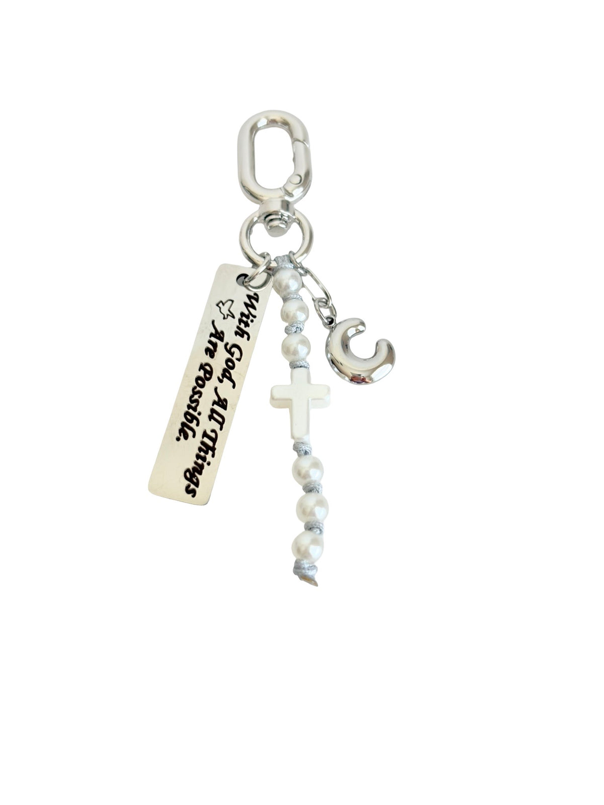 Silver-toned religious charm set featuring a carabiner clip, a rectangular bar engraved with 'With God, All Things Are Possible', a white cross, a beaded rosary, and a crescent moon charm on a plain white background.