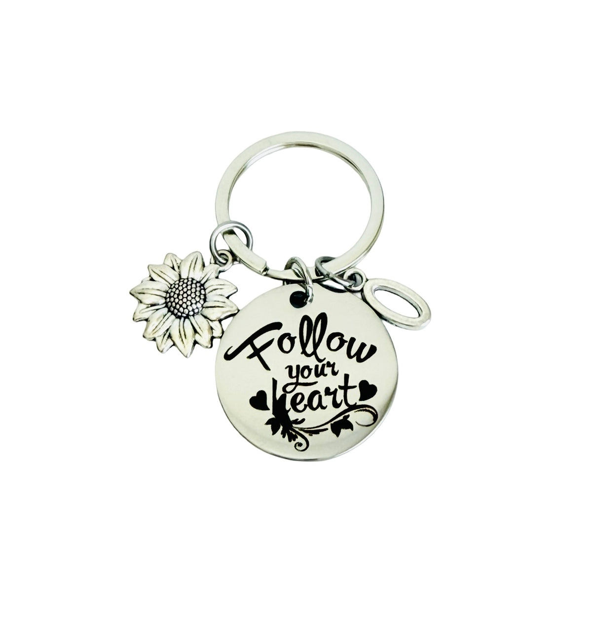 Keychain with sunflower charm and 'Follow your heart' tag on a white background