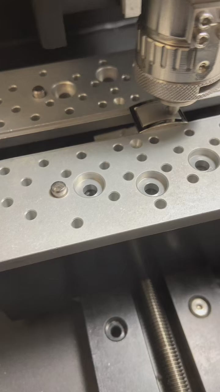 Load video: Close-up of personalized cufflink being engraved with custom initials