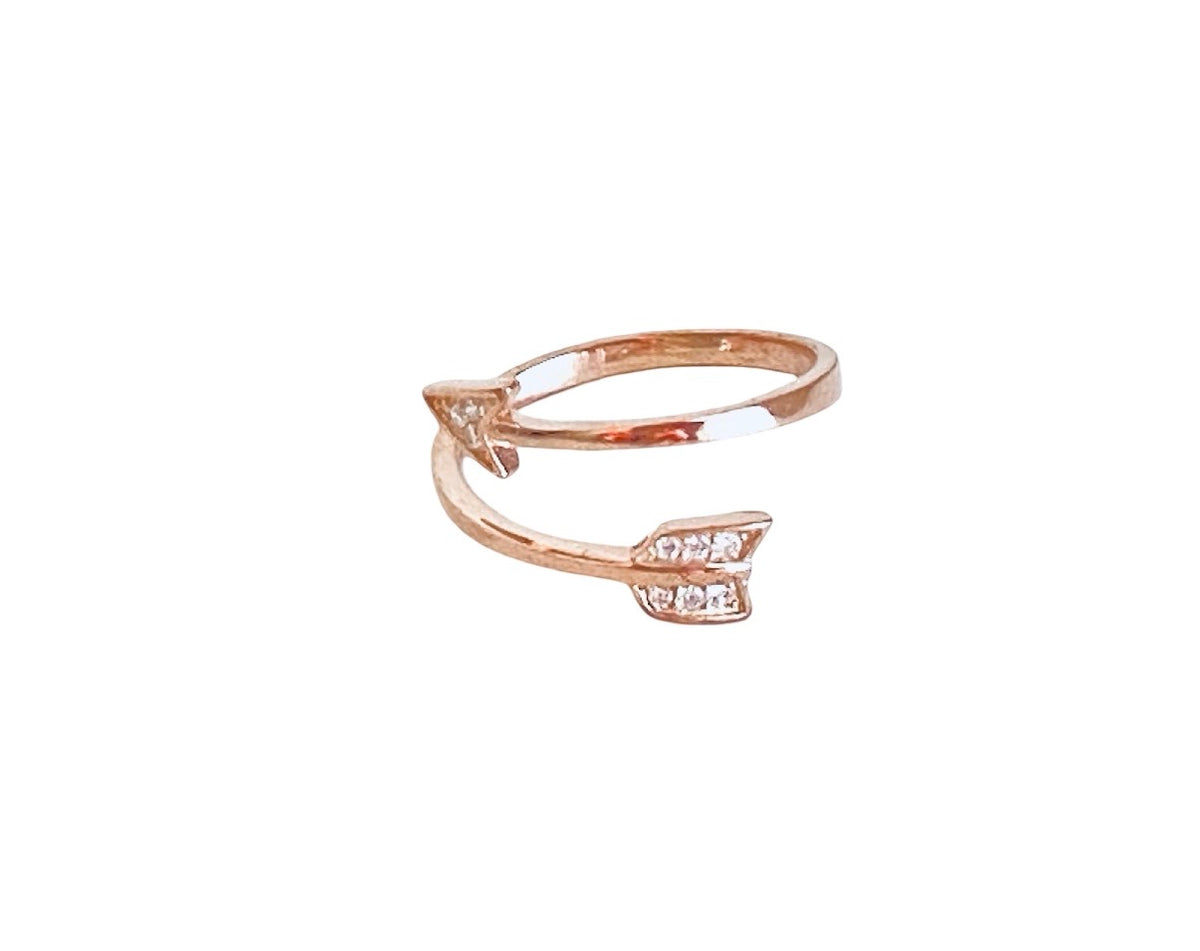 A rose gold open-band ring with a small arrowhead design set with clear pavé stones on the front, shown against a plain white background.