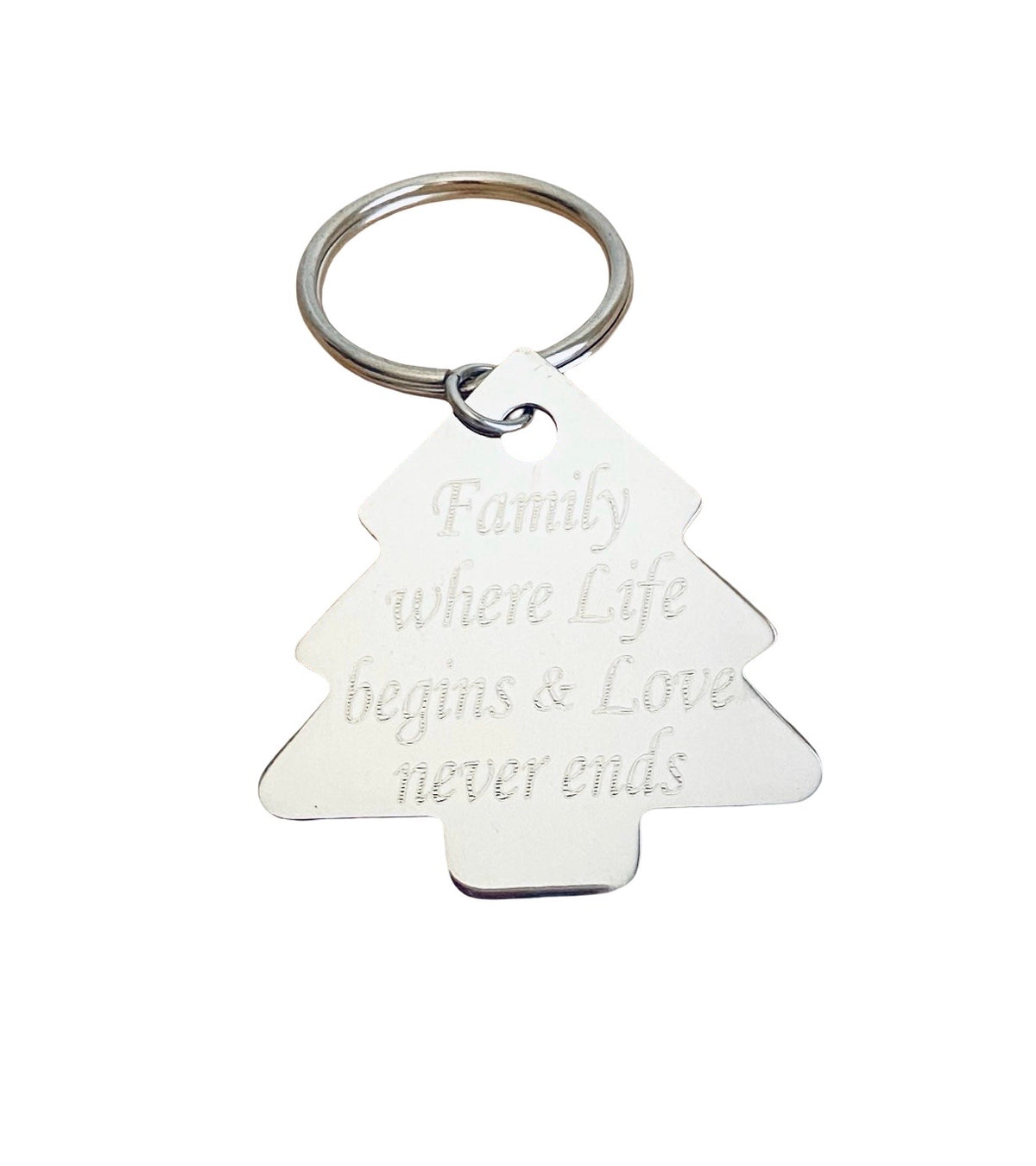 A silver metal keychain shaped like a Christmas tree with the engraved text 'Family where Life begins & Love never ends', attached to a silver split key ring on a plain white background.
